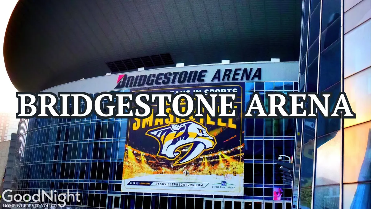 The iconic Bridgestone Arena sign stands out against the sleek modern architecture, with banners and signage indicating live events and the excitement of downtown Nashville nightlife.
